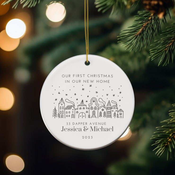 Personalised Round Ceramic Christmas Decoration with Festive Monochrome design of a row of Christmas Houses. Personalise with your house number/name, road name, family name or names, and year to complete the design for a truly wonderful keepsake.